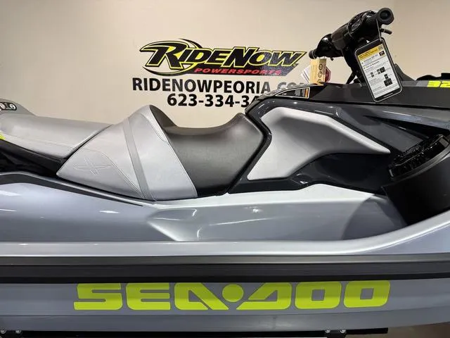 Slide: The Image of 2025 Sea-Doo RXT-X Waverunner displayed at RideNow Powersports showroom. - 14