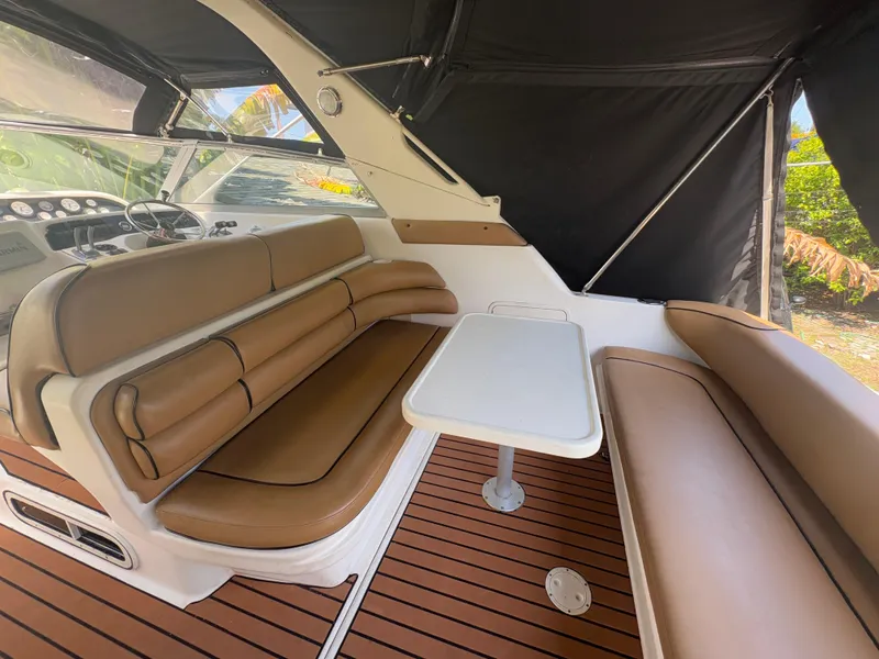 Slide: The Image of Interior of 1996 Sea Ray Sundancer 350 with brown seating and white table. - 11