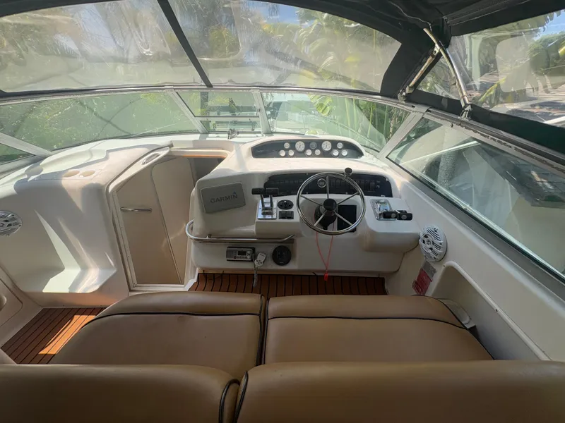 Slide: The Image of 1996 Sea Ray Sundancer 350 cockpit with steering wheel and navigation equipment. - 12