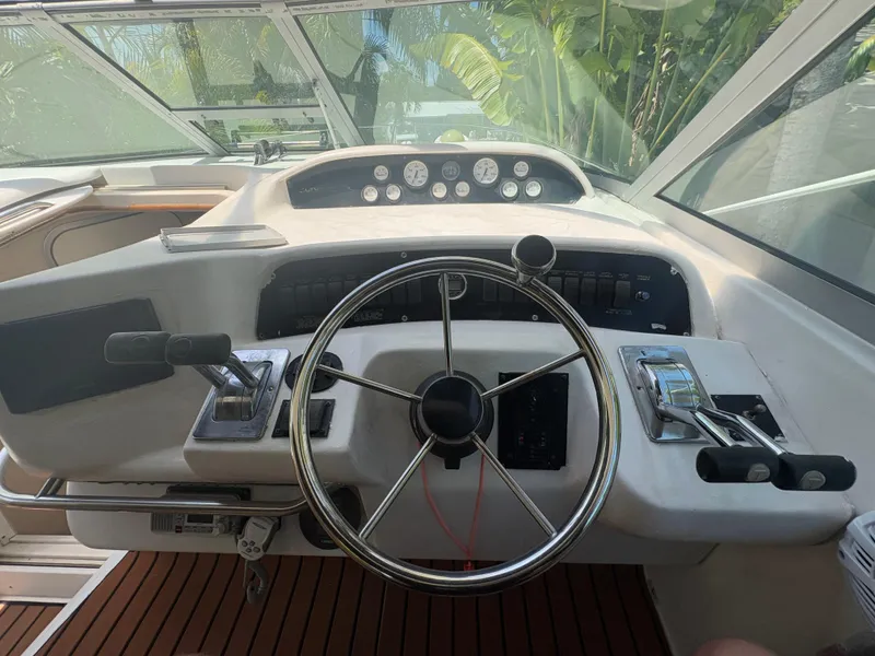 Slide: The Image of 1996 Sea Ray Sundancer 350 helm with steering wheel and control panel. - 13