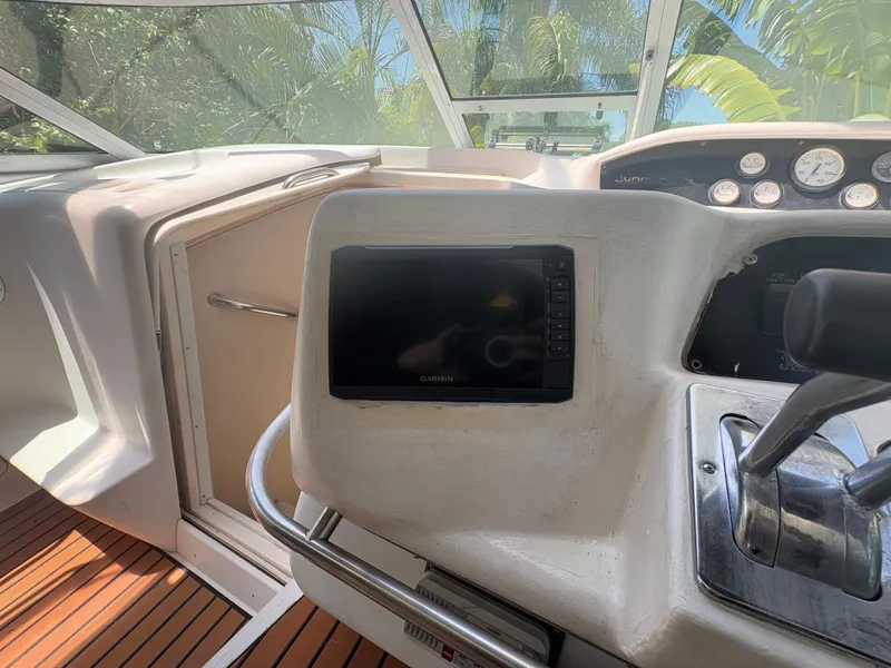 Slide: The Image of 1996 Sea Ray Sundancer 350 helm with Garmin display and controls, featuring wooden flooring. - 14