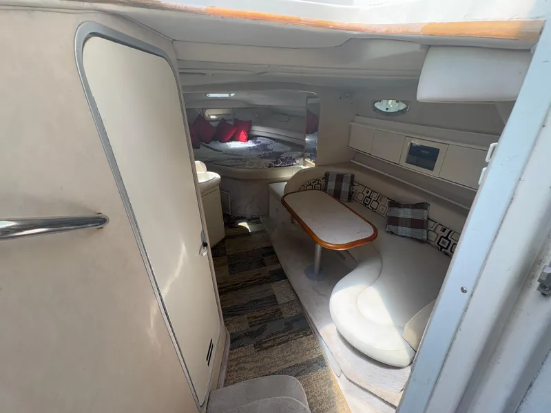 Slide: The Image of Interior of 1996 Sea Ray Sundancer 350 yacht with cozy seating and dining area. - 16
