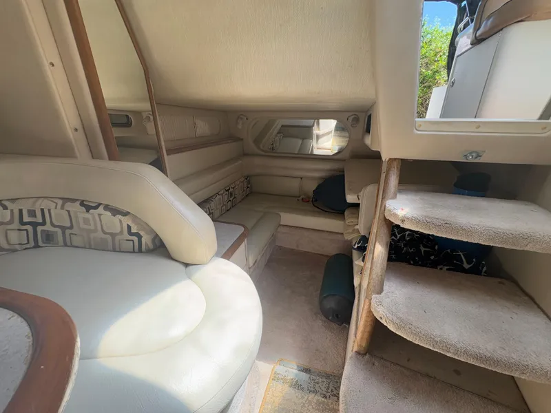 Slide: The Image of Interior of 1996 Sea Ray Sundancer 350, featuring seating and carpeted stairs. - 17