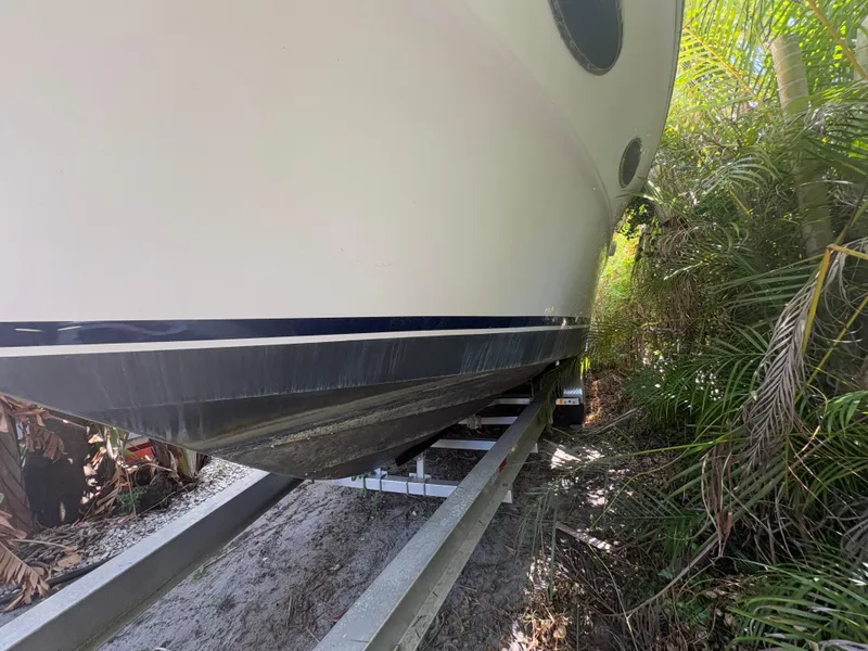 Slide: The Image of 1996 Sea Ray Sundancer 350 boat on trailer, surrounded by greenery. - 5