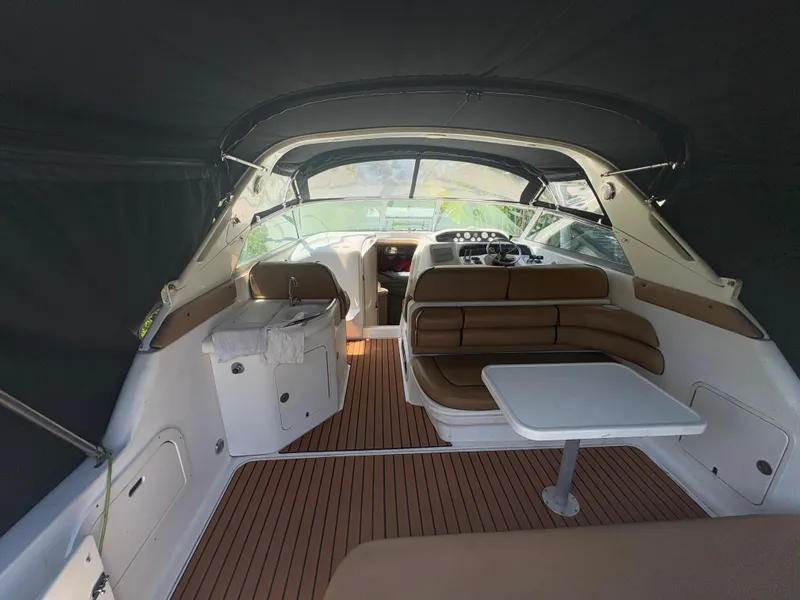 Slide: The Image of 1996 Sea Ray Sundancer 350 interior with seating and table, featuring a sleek design. - 9