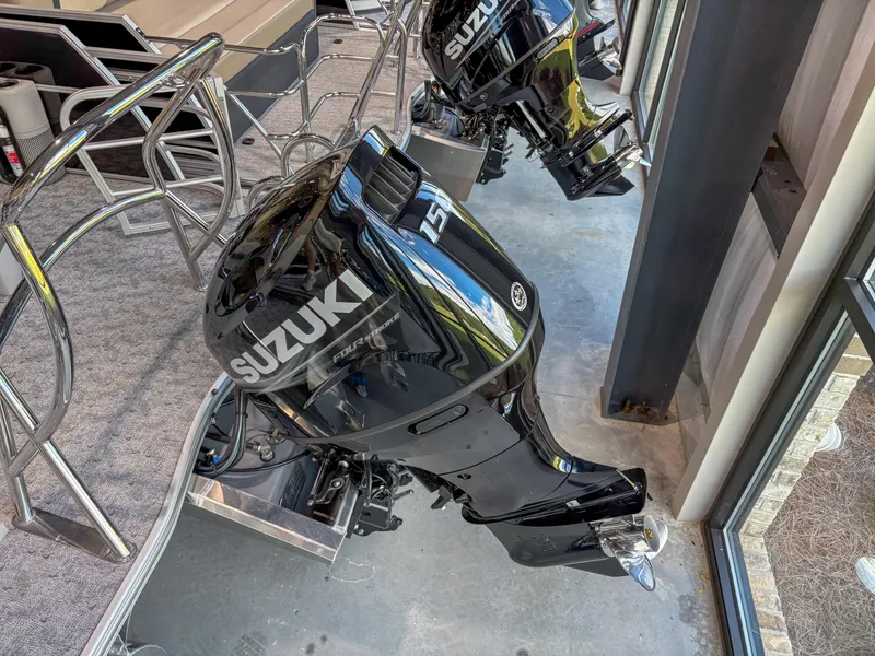 Slide: The Image of 2025 Trifecta 24 UL LE boat with Suzuki 150 outboard motor, displayed indoors. - 11