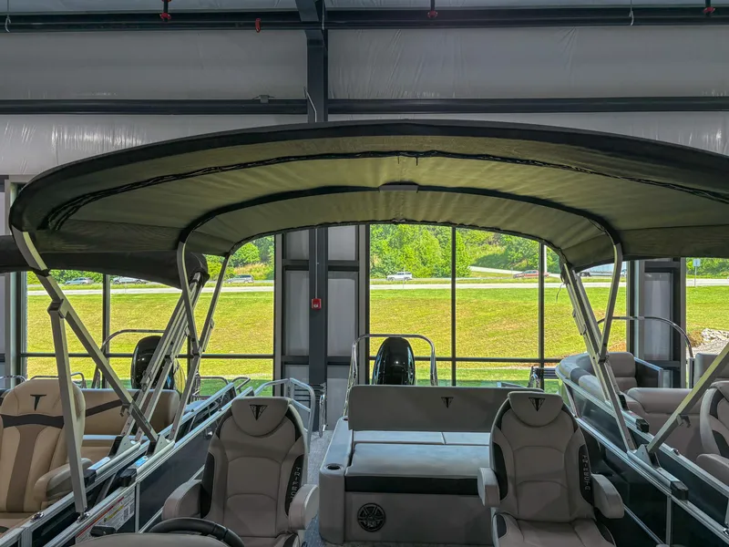 Slide: The Image of 2025 Trifecta 24 UL LE pontoon boat with canopy in showroom. - 12