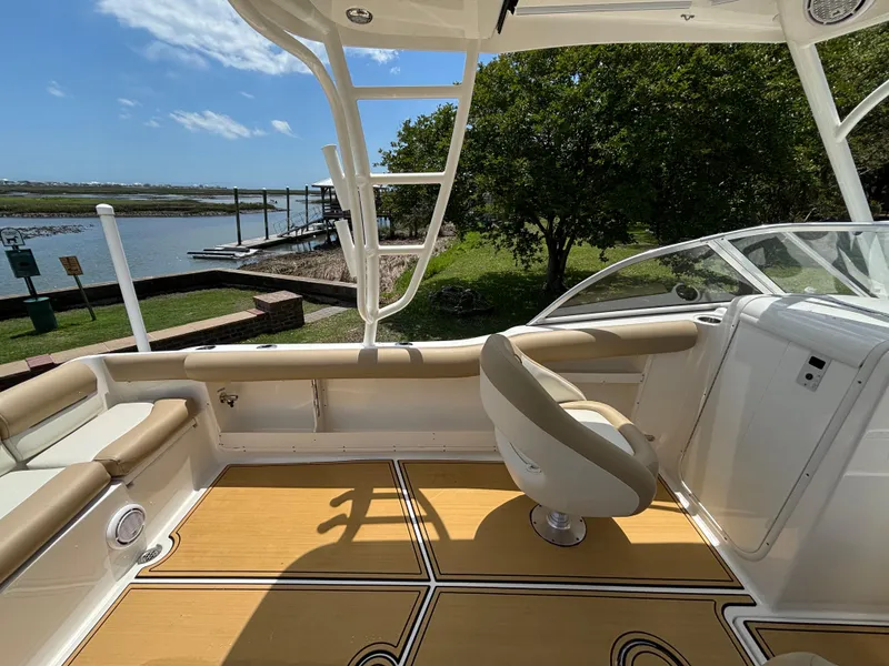 Slide: The Image of 2019 Key West 239 DFS boat interior with seating, near a scenic waterfront. - 10