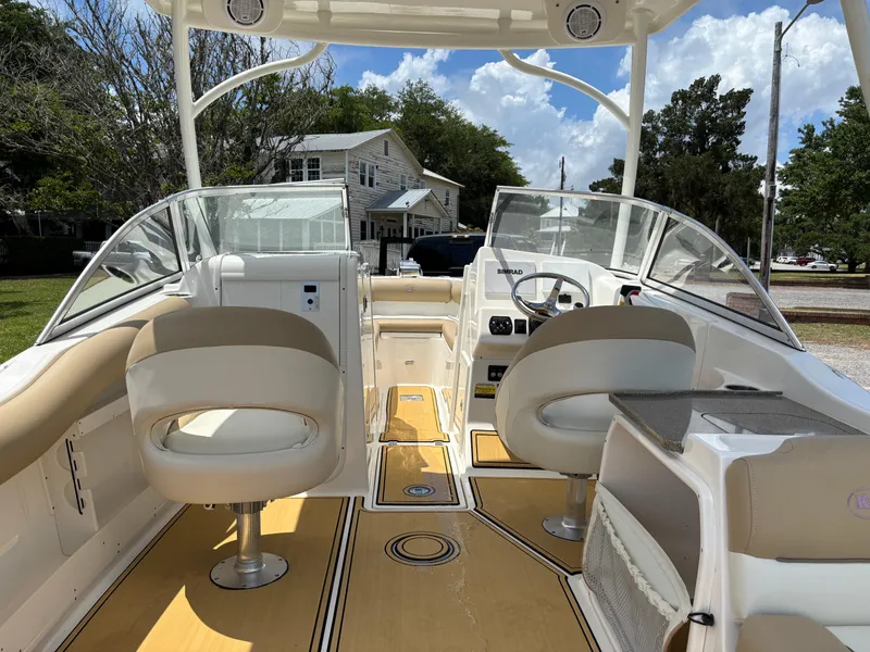Slide: The Image of 2019 Key West 239 DFS boat interior with beige seating and modern dashboard. - 3