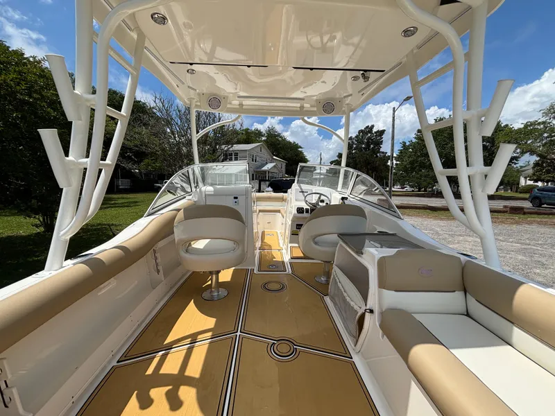 Slide: The Image of 2019 Key West 239 DFS boat interior with seating and helm, under a clear sky. - 6