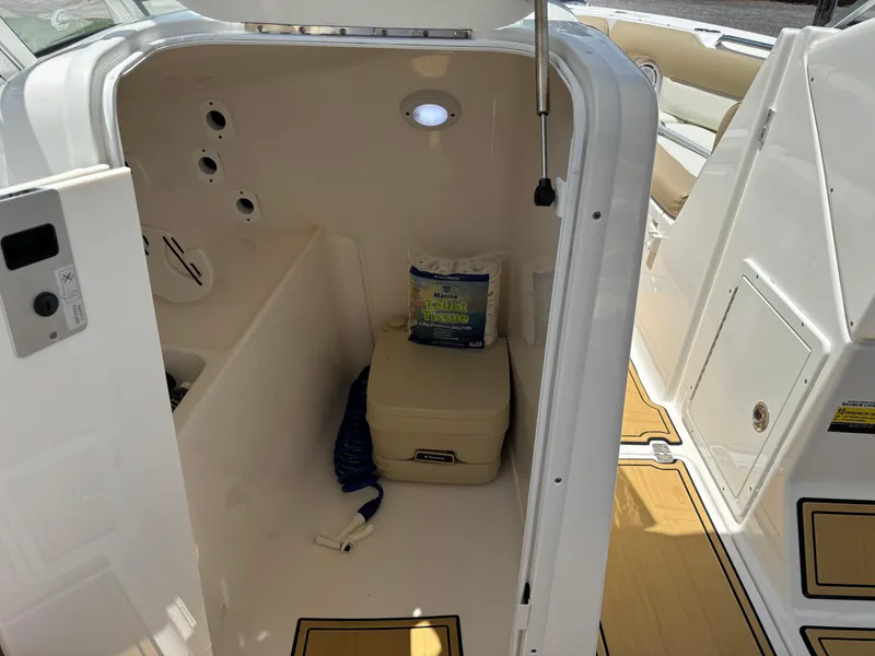 Slide: The Image of 2019 Key West 239 DFS boat interior with storage compartment and marine supplies. - 8