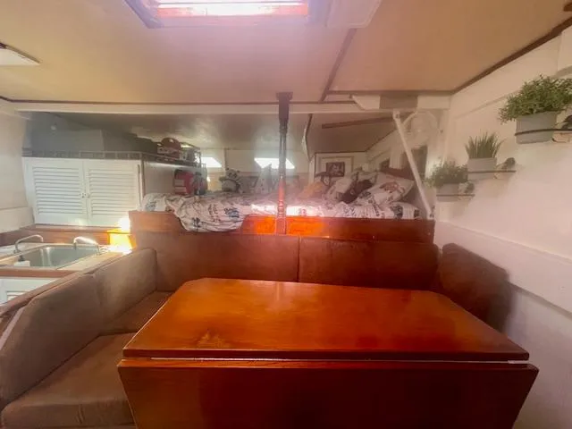 Slide: The Image of Interior of 1980 Custom Horstman Tristar Ketch with cozy seating and wooden table. - 12