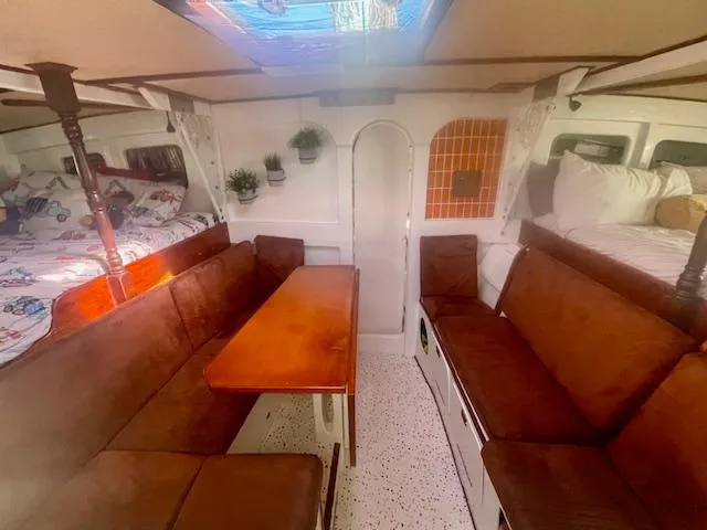 Slide: The Image of Interior of 1980 Custom Horstman Tristar Ketch with cozy seating and nautical decor. - 13