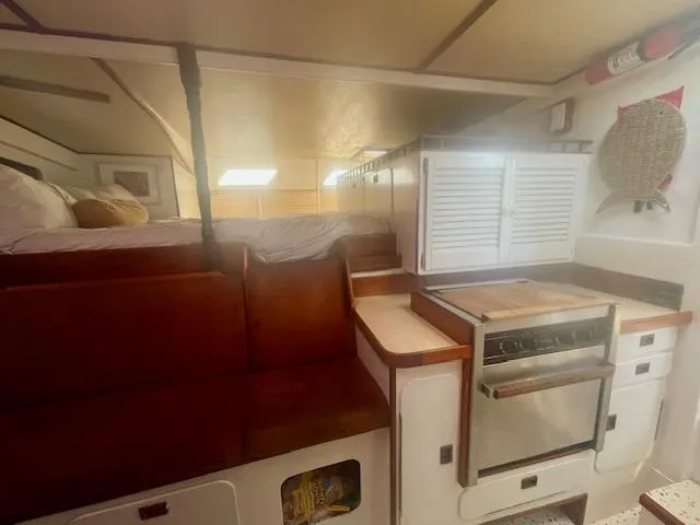 Slide: The Image of Interior of 1980 Custom Horstman Tristar Ketch with cozy seating and compact kitchen area. - 14