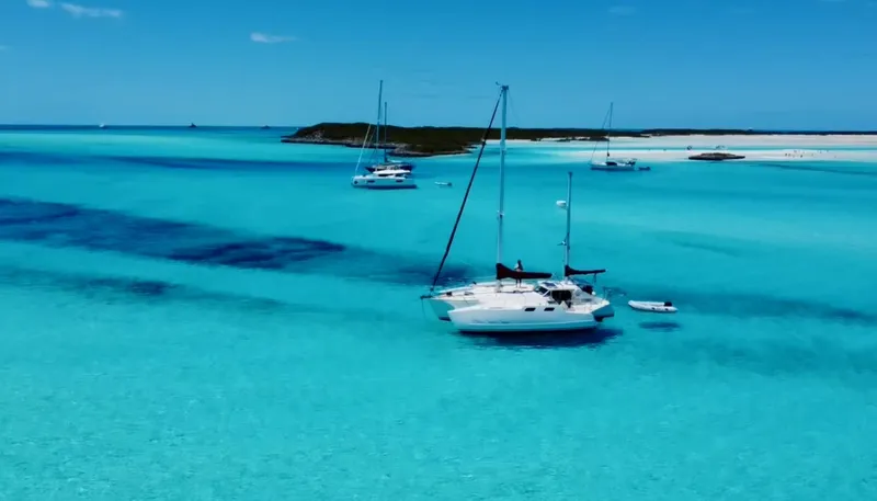 Slide: The Image of Sailboats anchored in clear turquoise waters, featuring a 1980 Custom Horstman Tristar Ketch. - 3