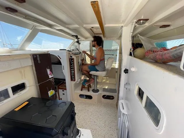 Slide: The Image of Interior of 1980 Custom Horstman Tristar Ketch with person at helm, bright and spacious. - 4