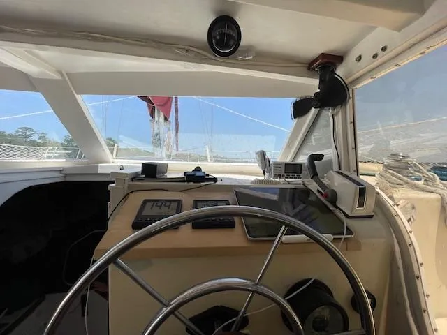 Slide: The Image of Cockpit view of 1980 Custom Horstman Tristar Ketch with steering wheel and navigation instruments. - 5