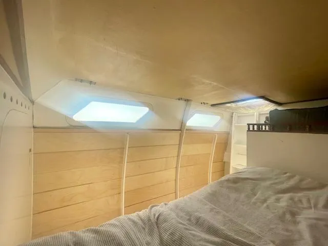 Slide: The Image of Interior cabin of 1980 Custom Horstman Tristar Ketch with wooden paneling and bedding. - 8