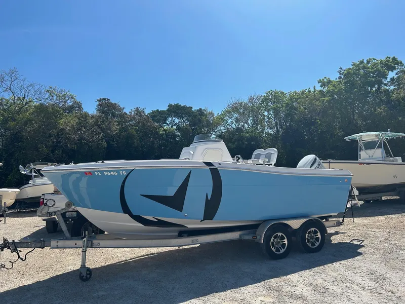 The Image of 2022 Aquasport 2100 boat on trailer, light blue hull, parked outdoors. - 0