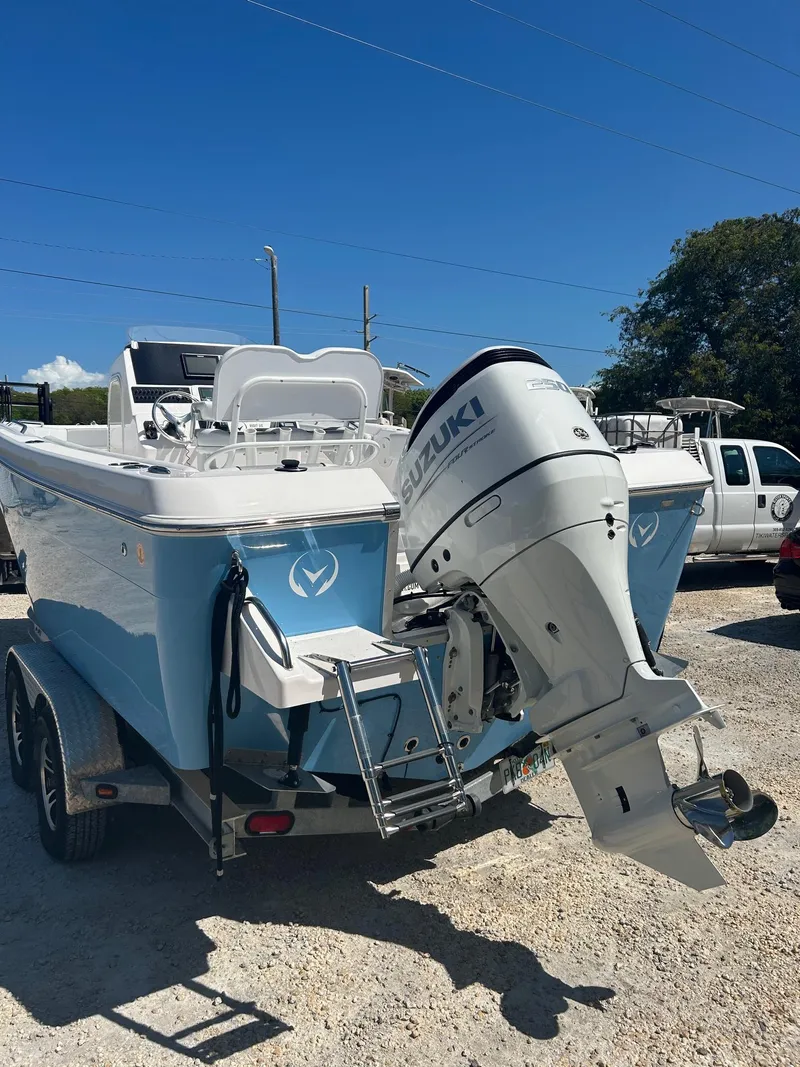 Slide: The Image of 2022 Aquasport 2100 boat with Suzuki outboard motor on a trailer. - 2