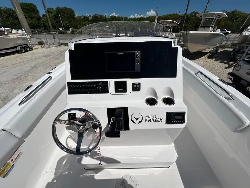 Slide: The Image of 2022 Aquasport 2100 boat dashboard with steering wheel and control panel. - 5