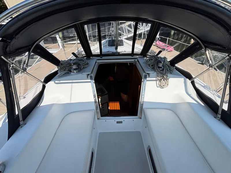 Slide: The Image of 1998 Catalina 320 sailboat cockpit with open cabin entrance and coiled ropes. - 14