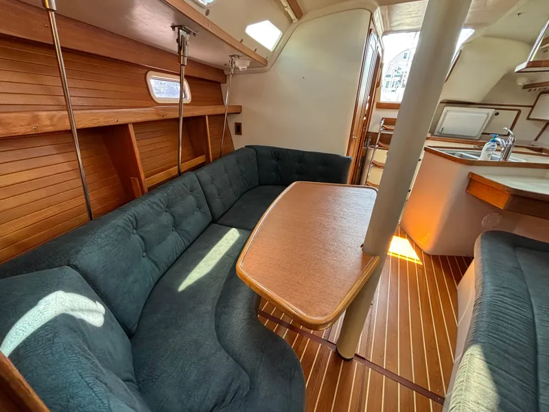 Slide: The Image of Interior of a 1998 Catalina 320 sailboat with wood accents and cozy seating area. - 30