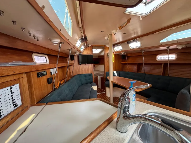 Slide: The Image of Interior of a 1998 Catalina 320 sailboat with wood finish and seating area. - 37
