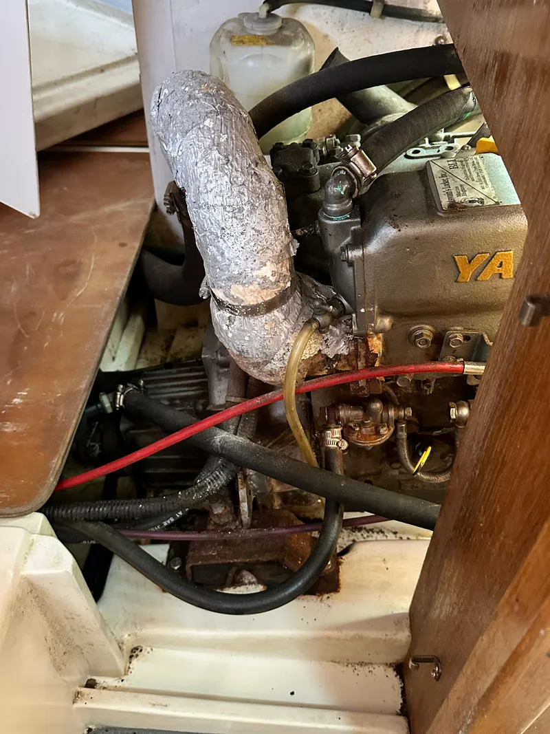 Slide: The Image of Engine compartment of a 1998 Catalina 320 sailboat, featuring a Yanmar engine. - 44