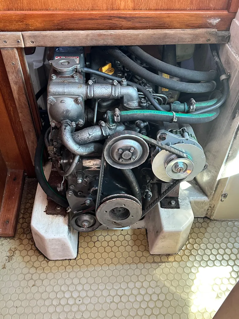 Slide: The Image of Engine of a 1998 Catalina 320 sailboat, showing belts and hoses. - 45