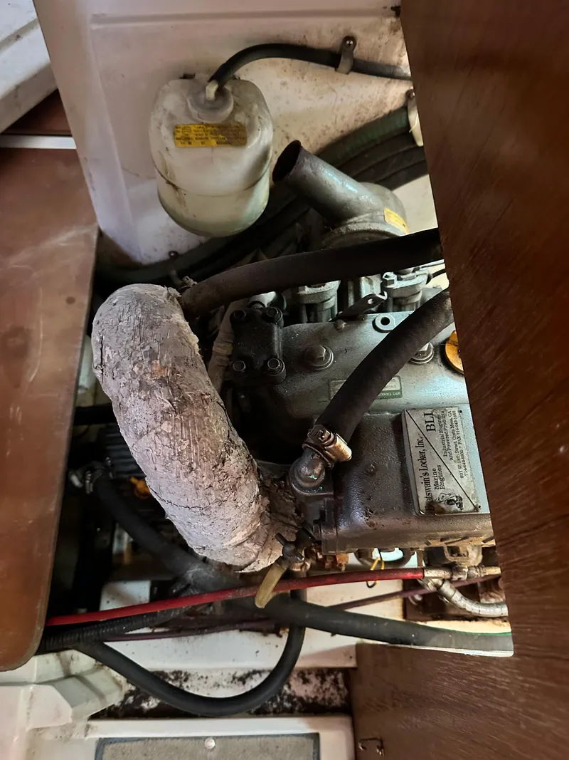 Slide: The Image of Engine compartment of a 1998 Catalina 320 sailboat, showing hoses and components. - 48