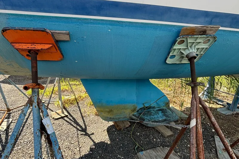 Slide: The Image of Catalina 320 sailboat hull on stands, showing keel and supports, 1998 model. - 6