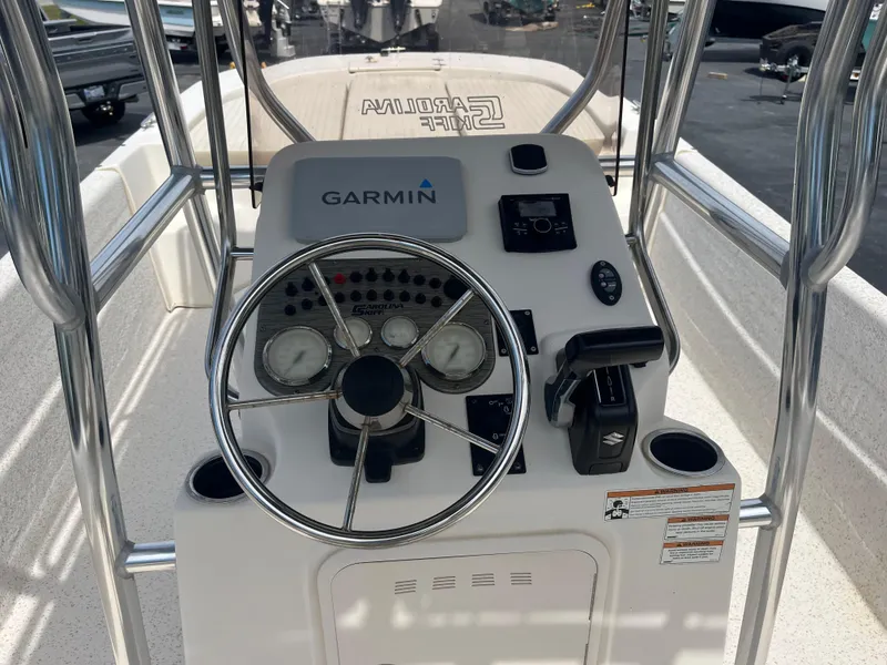 Slide: The Image of 2019 Carolina Skiff 238 DLV boat console with Garmin navigation system and steering wheel. - 12
