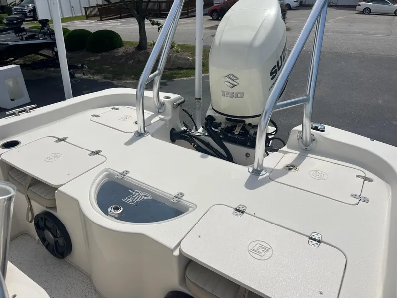 Slide: The Image of 2019 Carolina Skiff 238 DLV boat with Suzuki outboard motor, featuring spacious deck layout. - 18