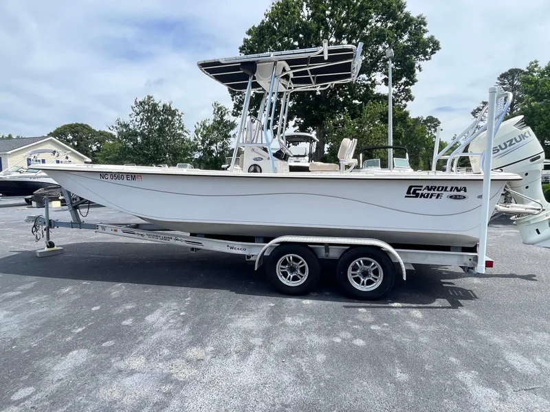 Slide: The Image of 2019 Carolina Skiff 238 DLV boat on trailer, parked outdoors. - 2