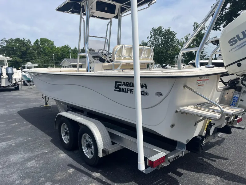 Slide: The Image of 2019 Carolina Skiff 238 DLV boat on trailer, parked outdoors. - 3