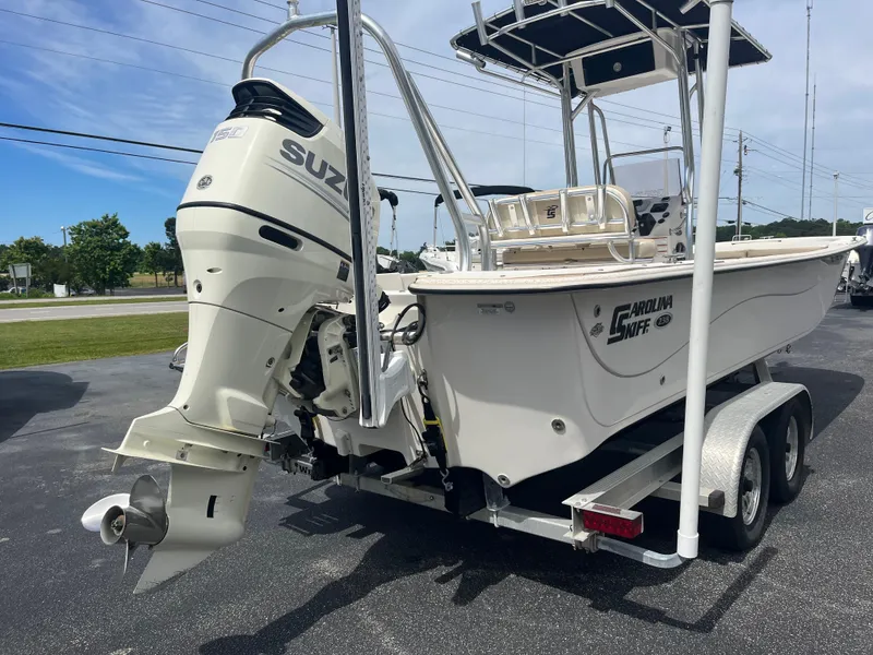 Slide: The Image of 2019 Carolina Skiff 238 DLV boat with Suzuki outboard motor on trailer. - 6