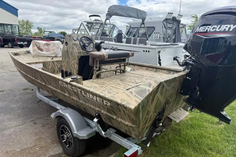 Slide: The Image of 2025 Crestliner 1860 Retriever CC Tunnel boat on trailer, camo design, overcast sky. - 2