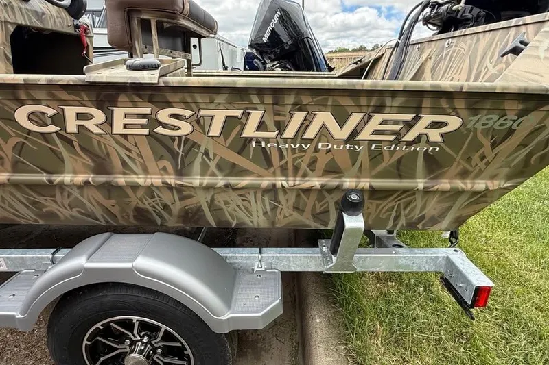 Slide: The Image of 2025 Crestliner 1860 Retriever CC Tunnel boat on trailer, camo design, heavy-duty edition. - 21
