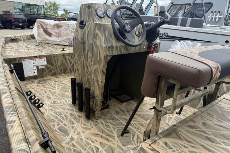 Slide: The Image of 2025 Crestliner 1860 Retriever CC Tunnel boat with camouflage design and Mercury outboard motor. - 6