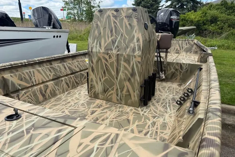 Slide: The Image of 2025 Crestliner 1860 Retriever CC Tunnel boat dashboard with camo design and control panel. - 8