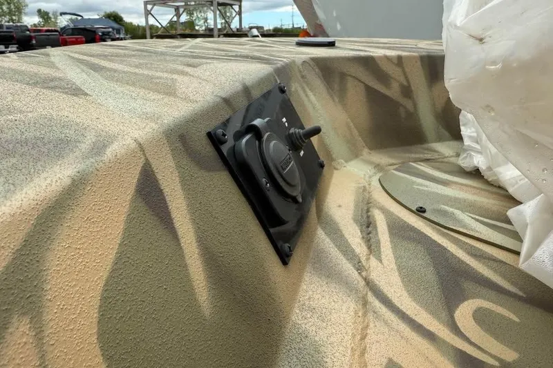 Slide: The Image of 2025 Crestliner 1860 Retriever CC Tunnel boat with camouflage design on a trailer. - 9