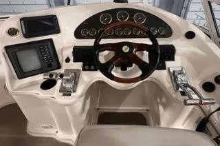 Slide: The Image of 2003 Cruisers Yachts 3750 Motoryacht helm with steering wheel and navigation controls. - 19