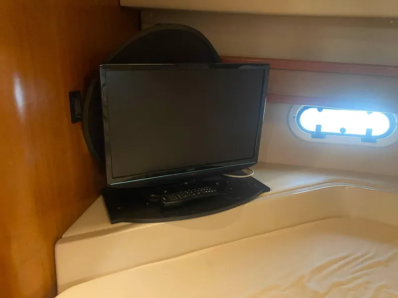 Slide: The Image of 2003 Cruisers Yachts 3750 Motoryacht interior with TV and porthole window. - 49