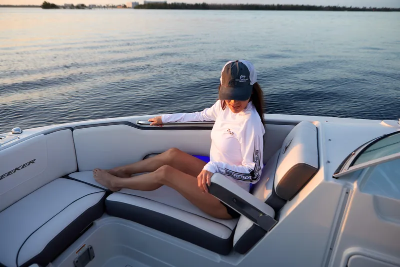 Slide: The Image of Woman relaxing on a 2026 Finseeker 240 DC boat at sunset. - 11