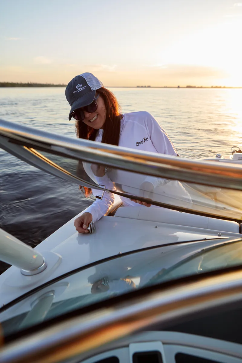 Slide: The Image of Woman enjoying sunset on a 2026 Finseeker 240 DC boat. - 12