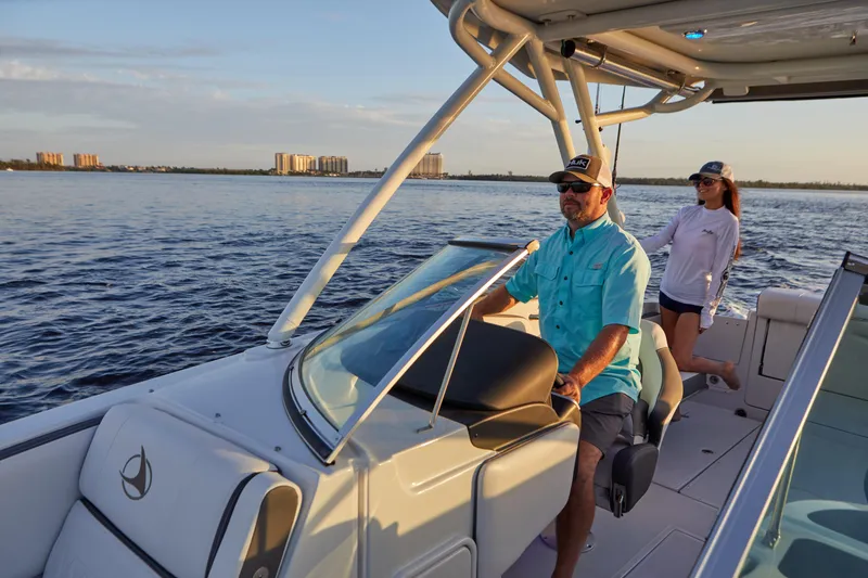 Slide: The Image of 2026 Finseeker 240 DC boat cruising with two people on a sunny day. - 8