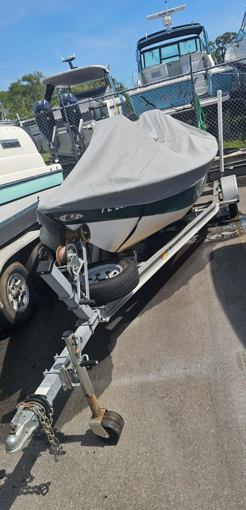 Slide: The Image of Covered 1999 Aqua Force Fish Hawk boat on trailer in parking lot. - 3