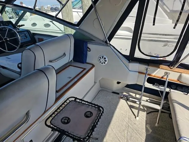 Slide: The Image of Interior of 1988 Sea Ray 340 Sundancer boat with seating and steering wheel. - 10