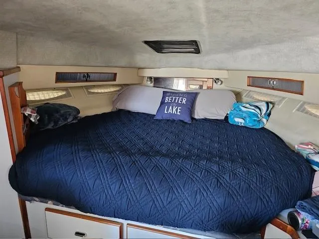 Slide: The Image of Cozy cabin interior of 1988 Sea Ray 340 Sundancer with a comfortable bed and decorative pillow. - 23